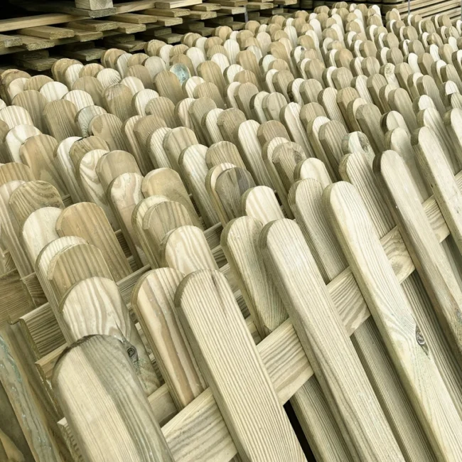 a batch of green treated high quality picket fencing